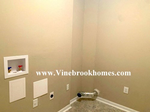 a bathroom with a sink and a wall with a shelf