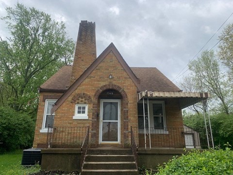 a small brick house with a large tower