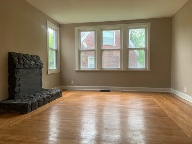 a living room with a fireplace and a wooden floor