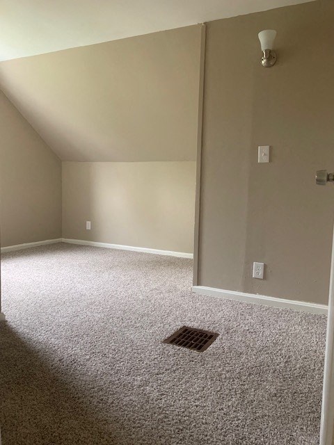 an empty room with a drain in the floor