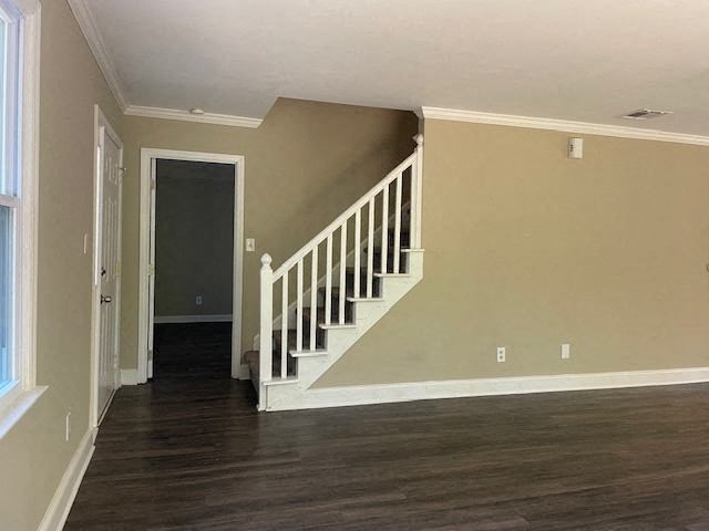 a living room with a staircase and a door