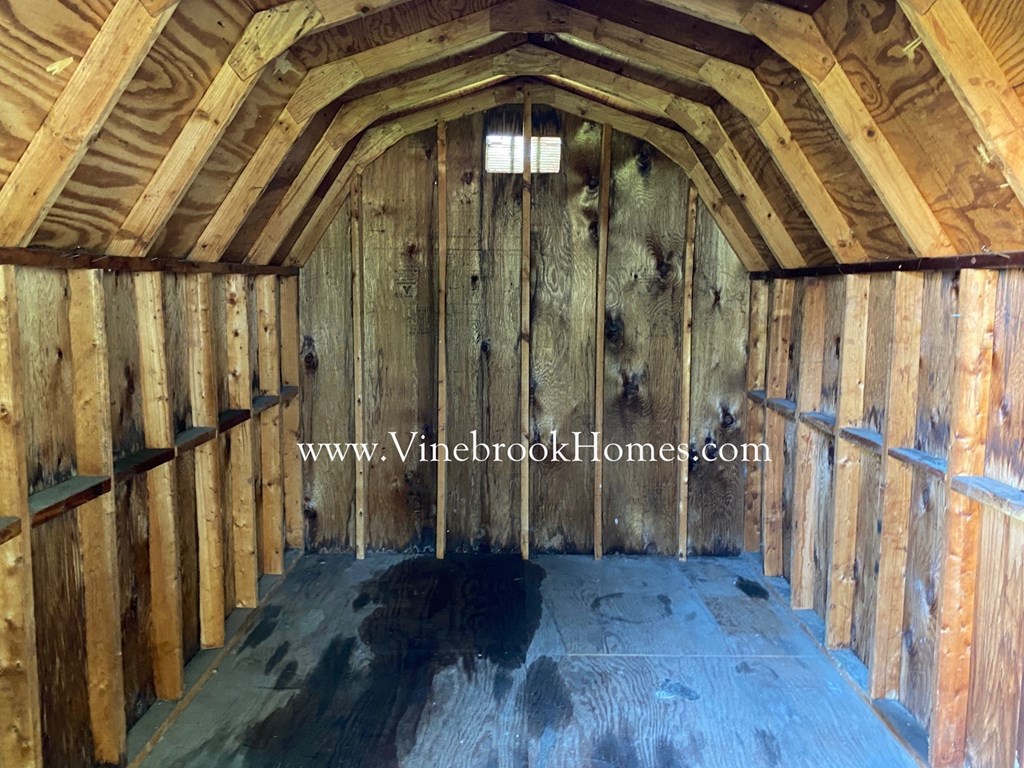 the inside of a barn with wooden walls and floors