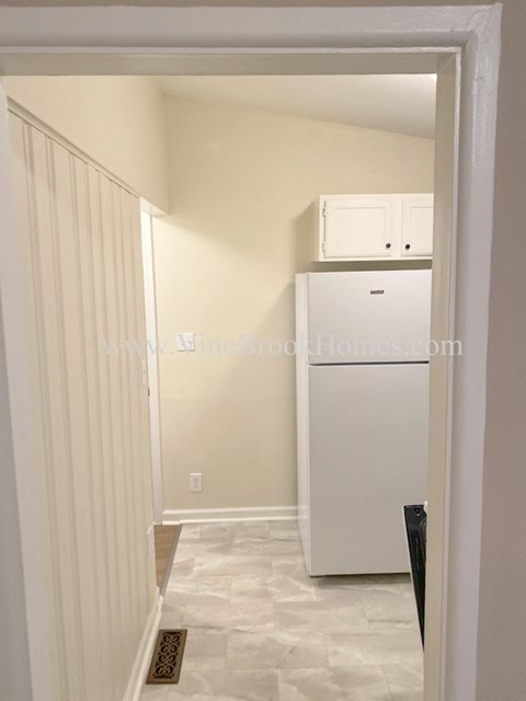 a small kitchen with a refrigerator and a microwave