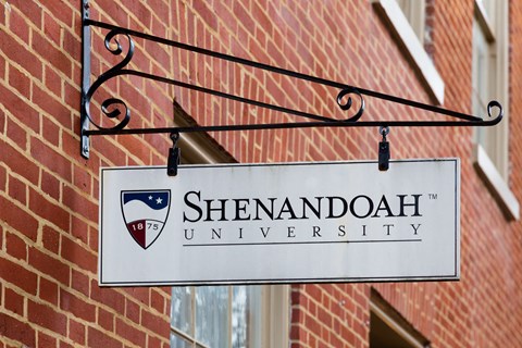 a sign in front of a brick building