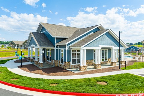 a blue house with a porch and a playground