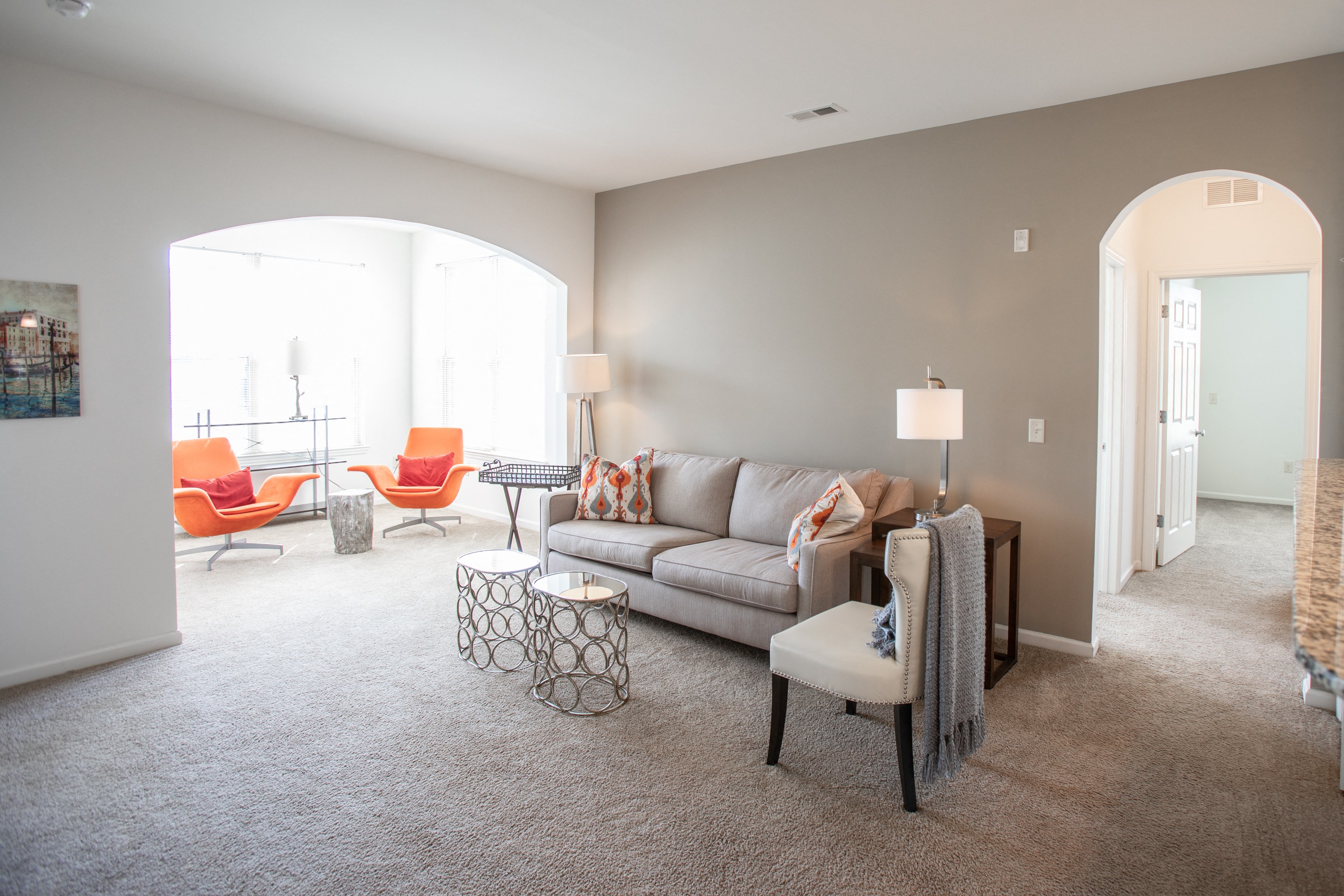 a living room with a couch and chairs and a table