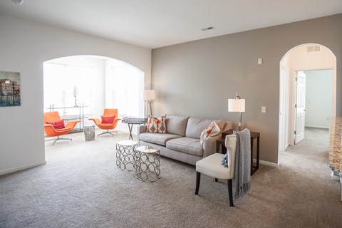 a living room with a couch and chairs and a table