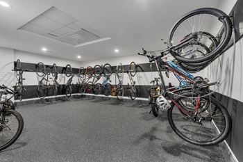 A bike shop with many bikes hanging on the wall.