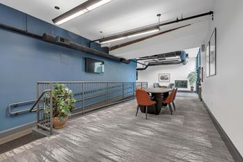 A room with a blue wall and a table with chairs.