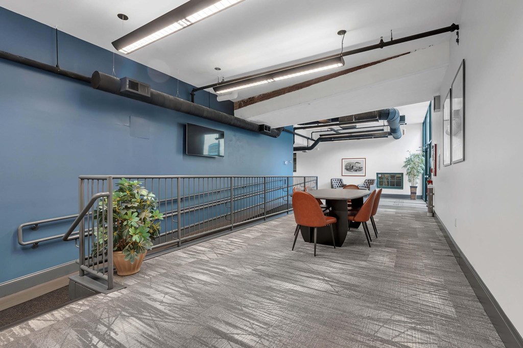 A room with a blue wall and a table with chairs.