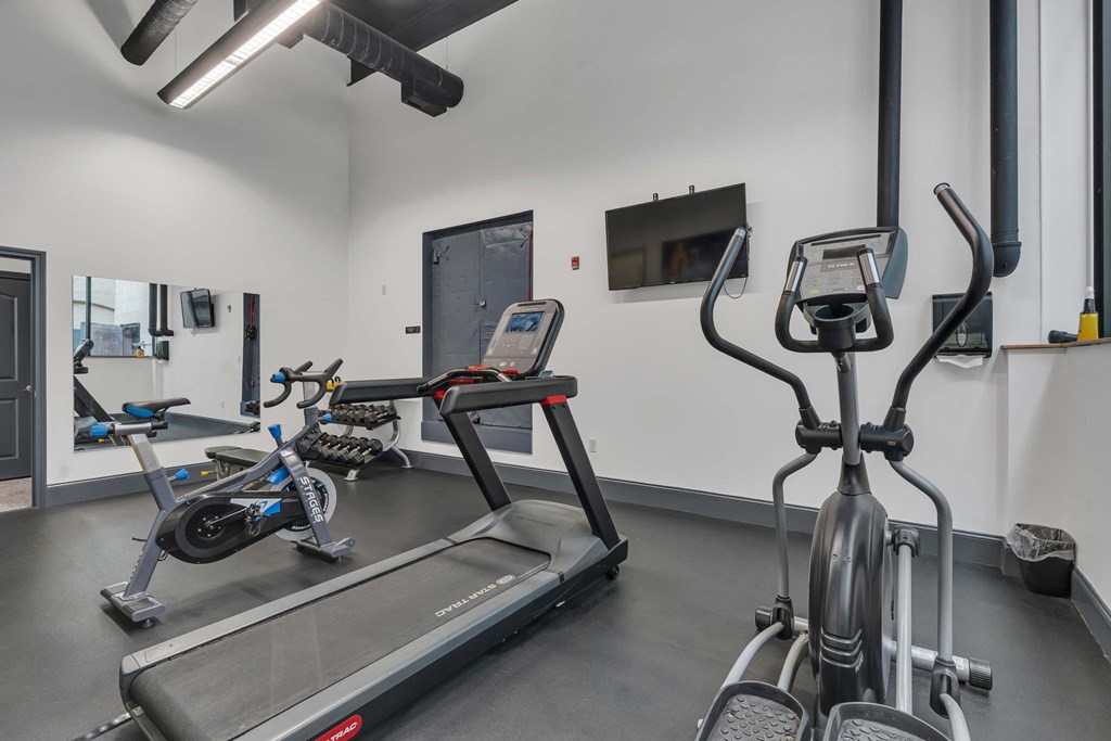 A gym with treadmills and exercise bikes.