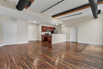 A room with wooden floors and white walls.