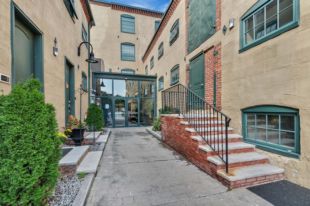 A building with a green door and a brick wall.