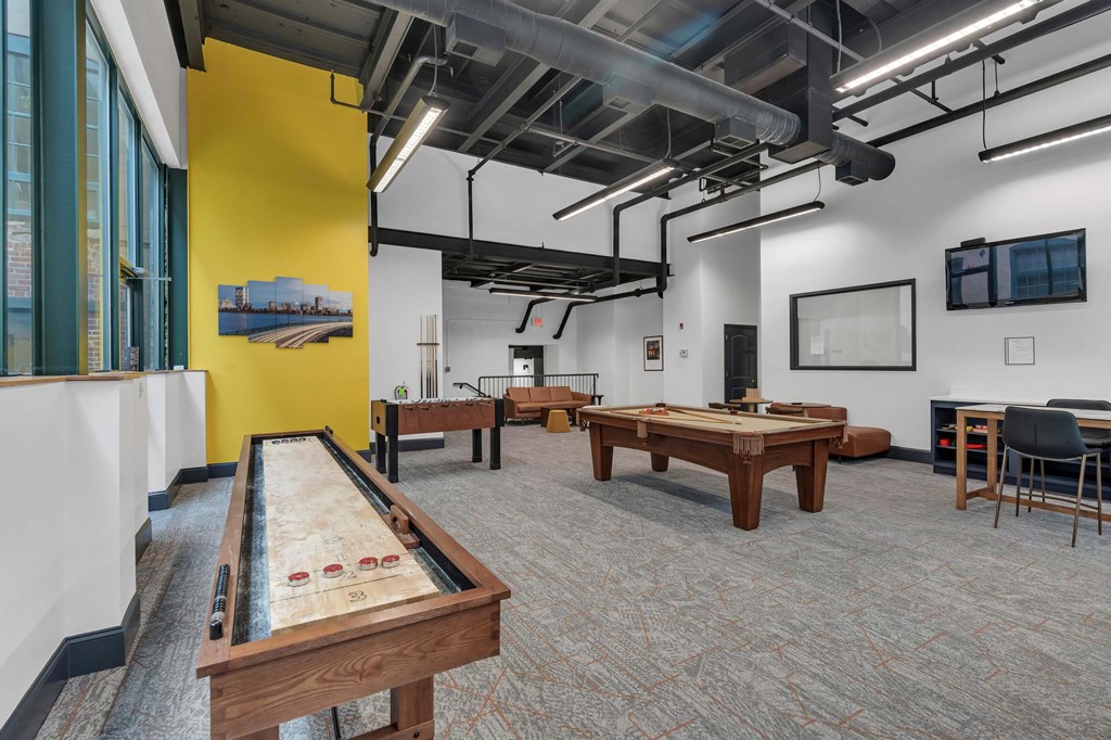 A room with a pool table and a yellow wall.