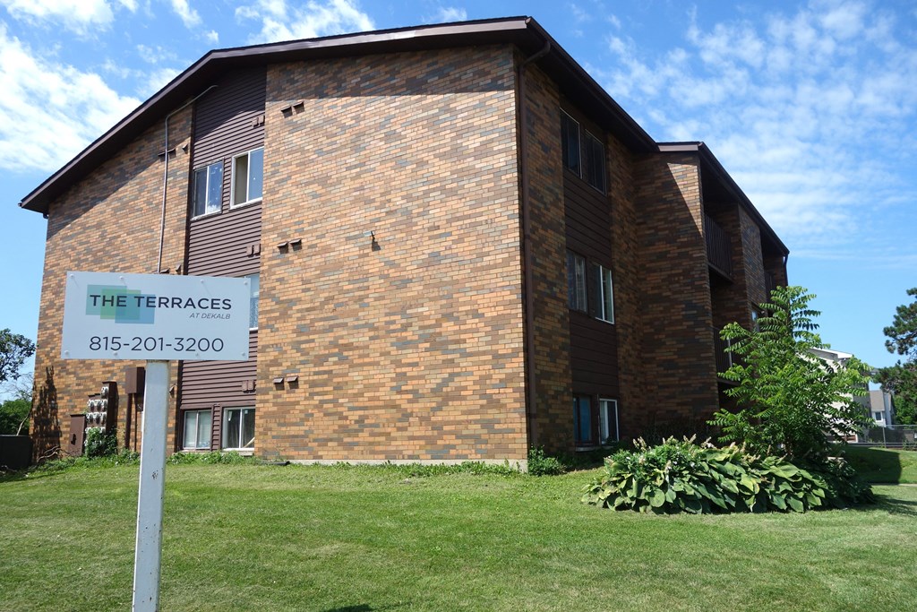 a brick building with a sign for the terraces