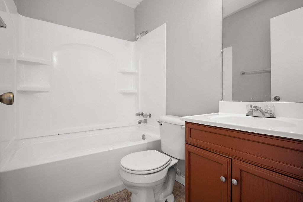 an empty bathroom with a toilet and a sink