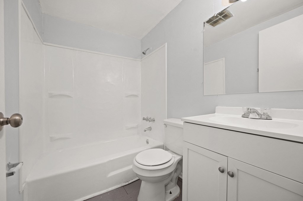 a bathroom with a sink toilet and a bath tub