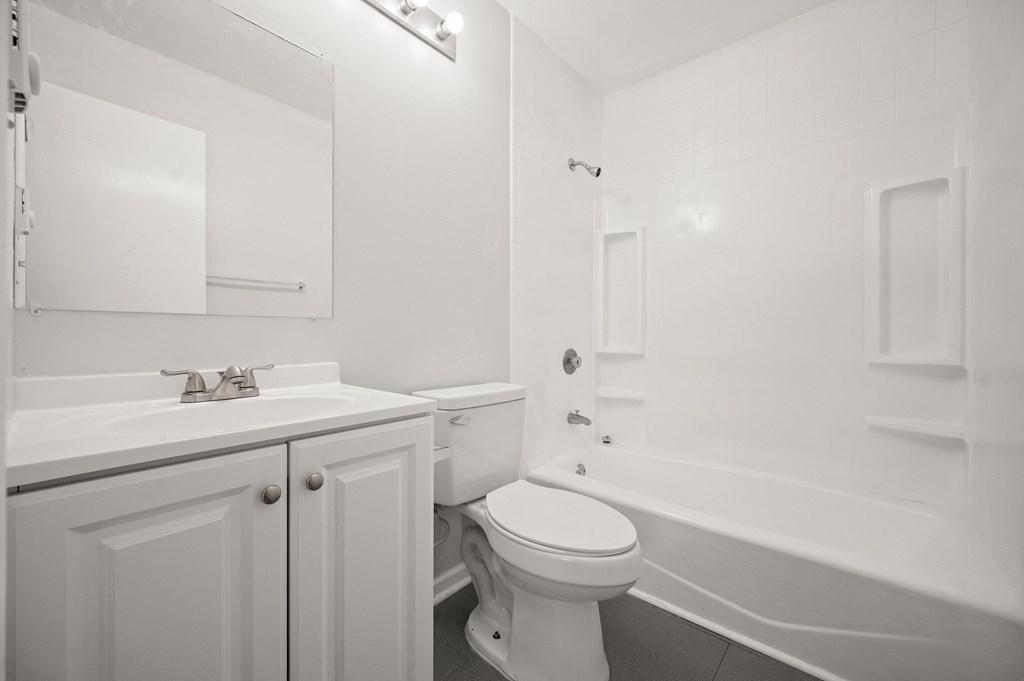 a bathroom with a sink toilet and a bath tub