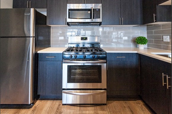 a kitchen with a stainless steel stove and a microwave