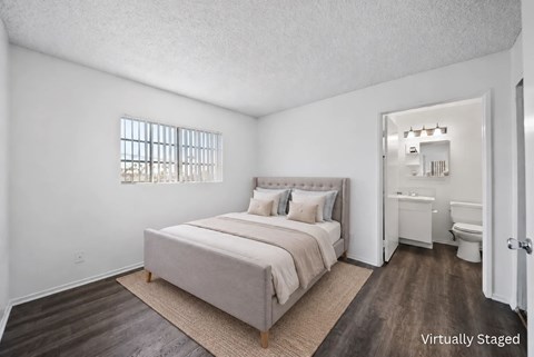 A bedroom with a bed, nightstand, and toiletries in a virtual staging.