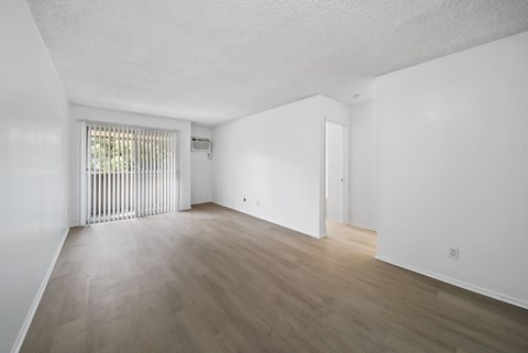 A room with wooden floors and white walls.