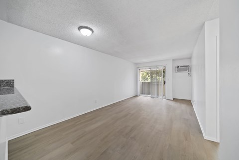 A room with a white ceiling and wooden flooring.