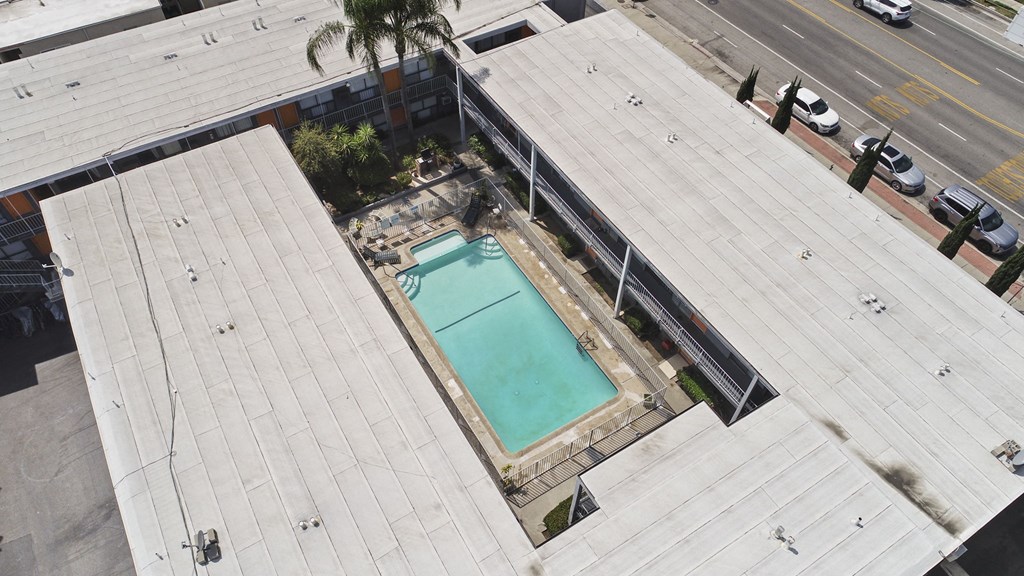 A small pool is surrounded by a concrete patio.