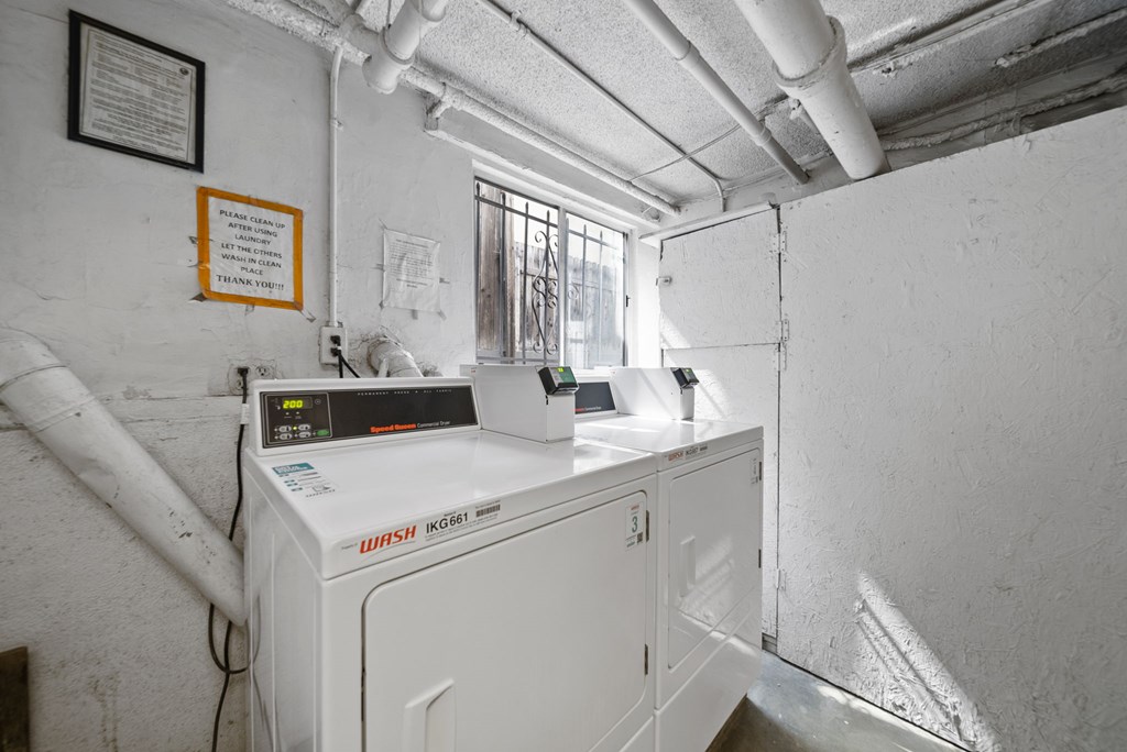 A Wash OGI washing machine is sitting in a small room.