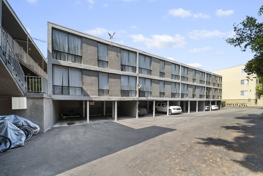 A large building with a parking lot in front of it.