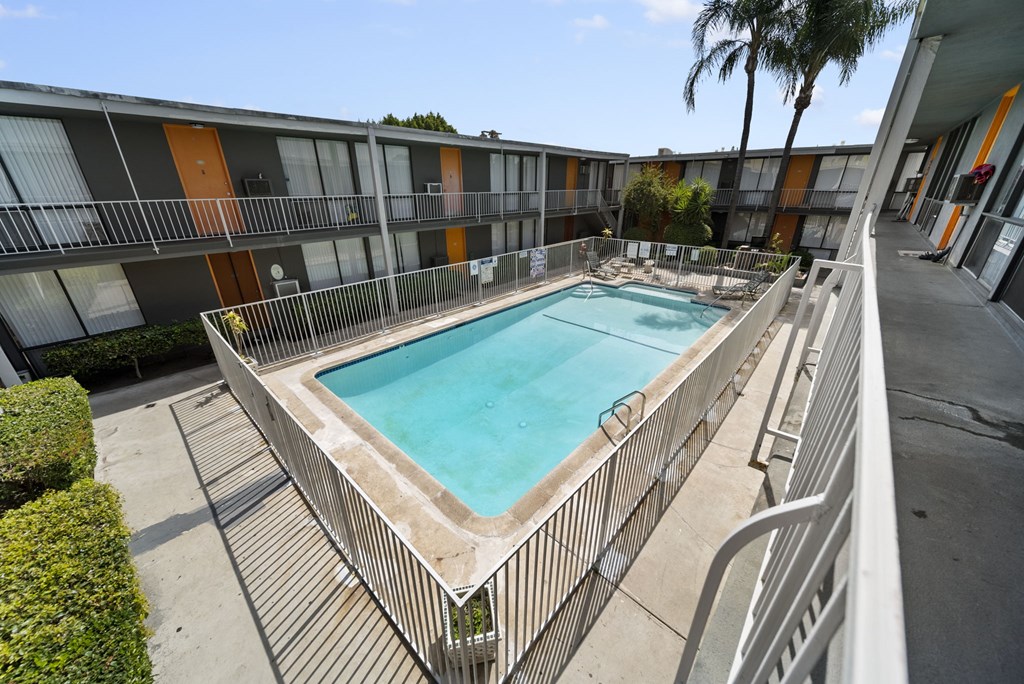 A rectangular pool with a metal fence around it.