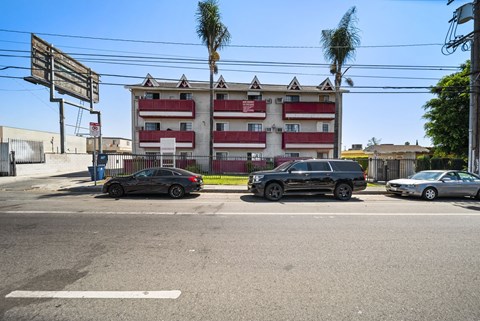 A black car is parked on the left side of the street.