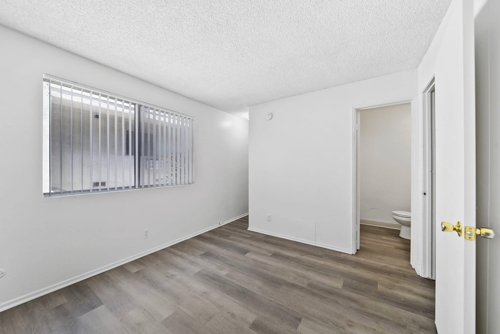 A room with a window and a door.