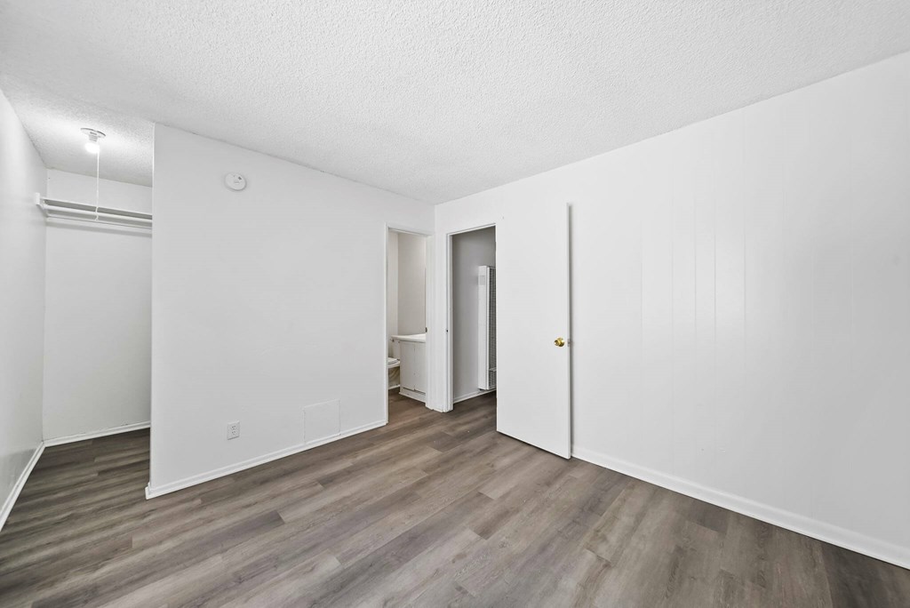 A room with white walls and a wooden floor.