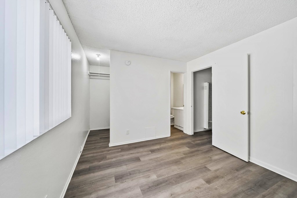 A room with a white door and a white wall.