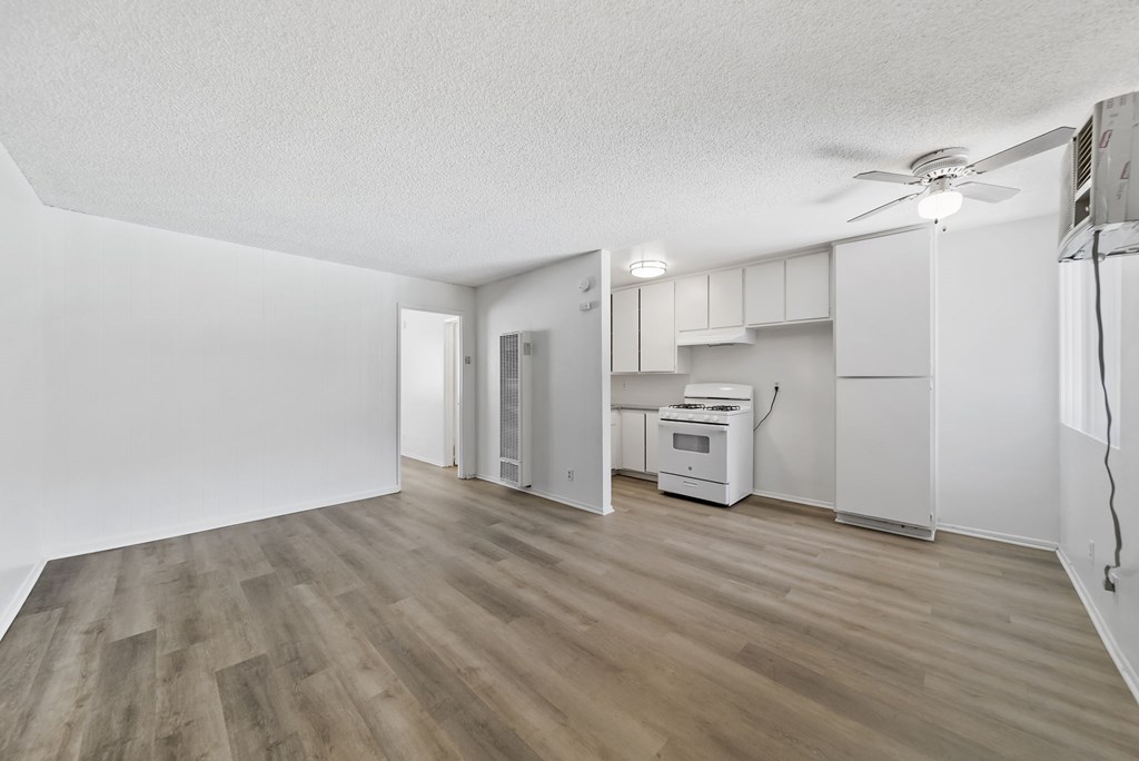 A room with a wood floor and white walls.