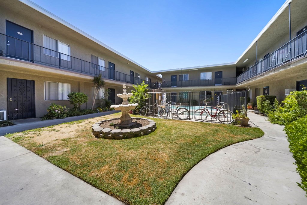 A courtyard with a fountain and bicycles.