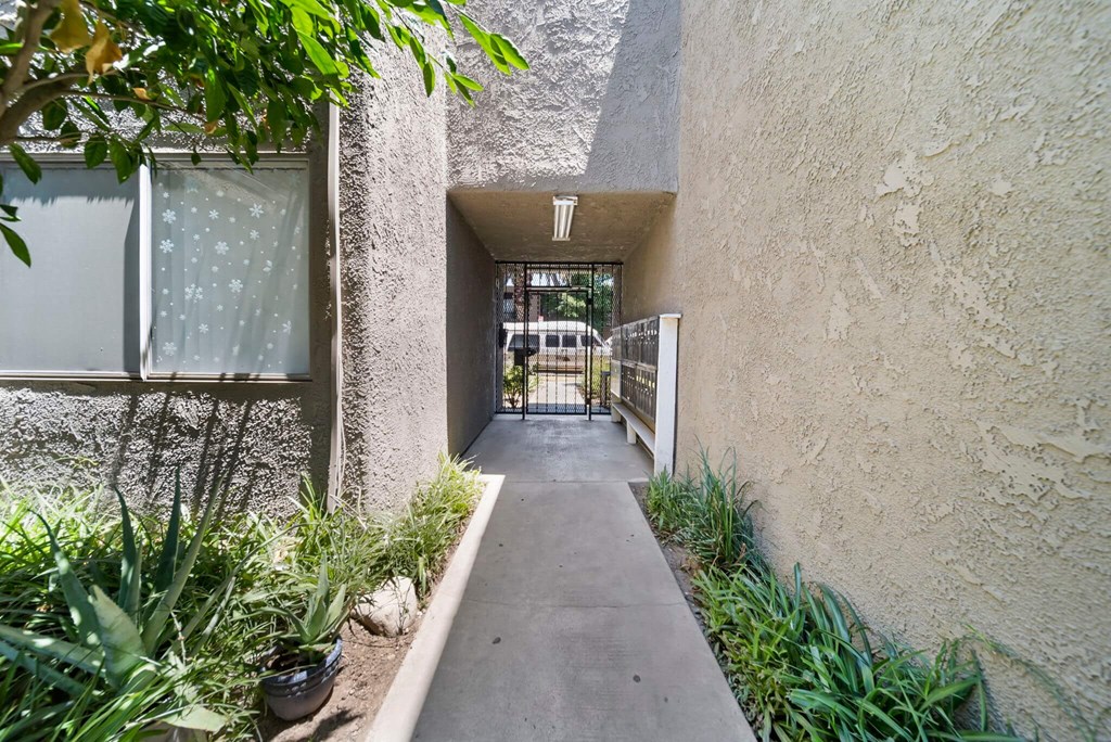 A pathway leads to a gate in a courtyard.