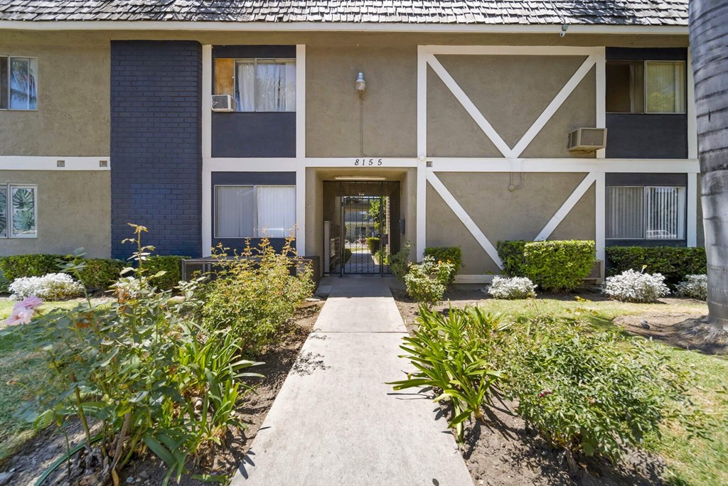 A building with a white and beige facade has a number 2155 on it.