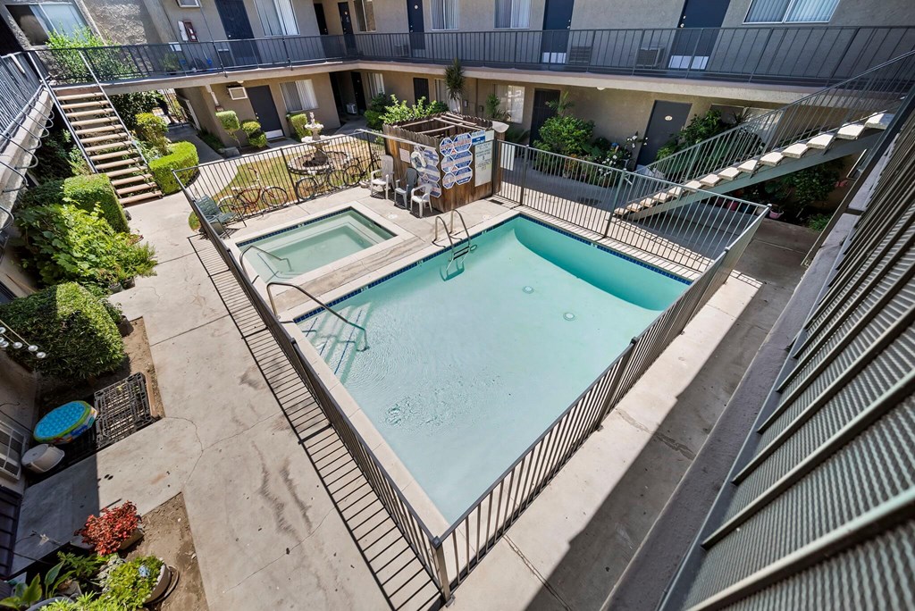 A small pool surrounded by a metal fence.