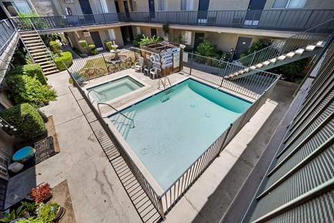 A small pool surrounded by a metal fence.