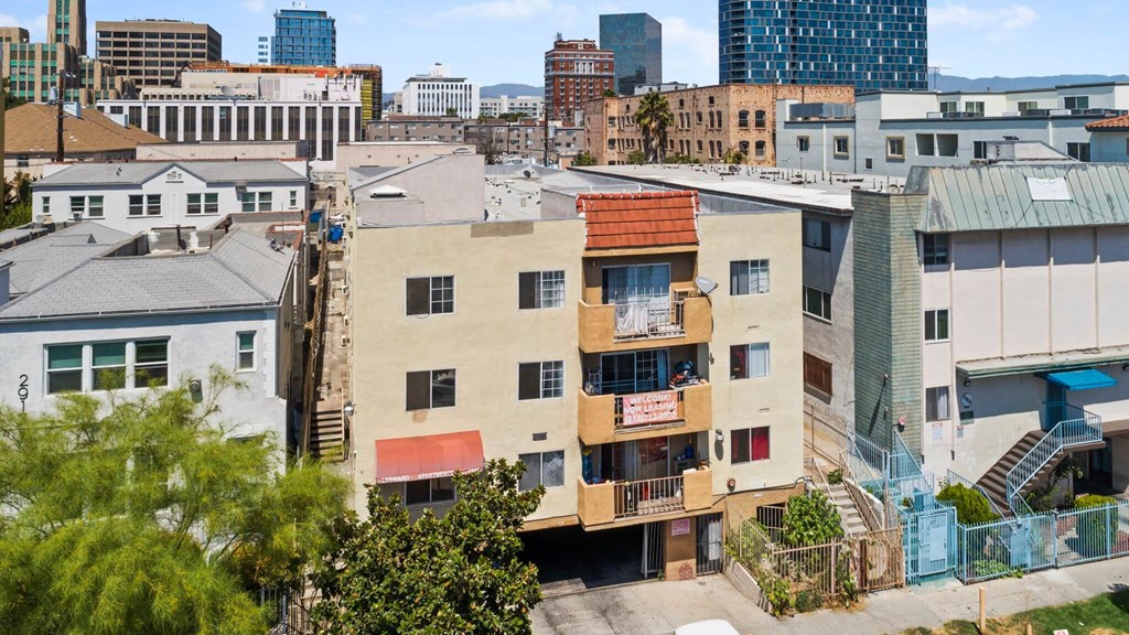 A view of a city with buildings of different heights and colors.