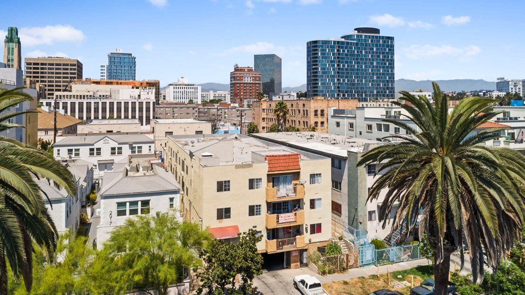 A cityscape with buildings and palm trees.