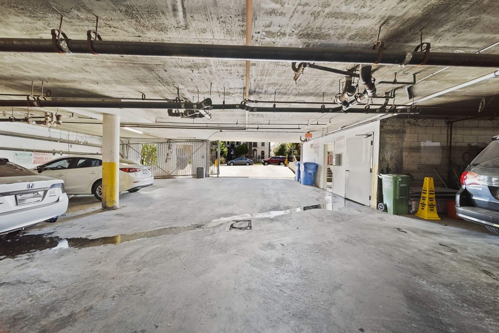 A parking garage with a white car parked on the left side.