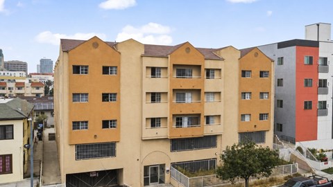 A large building with a yellow and orange facade.