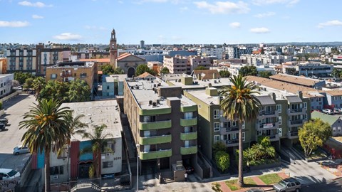 A cityscape with buildings and palm trees.