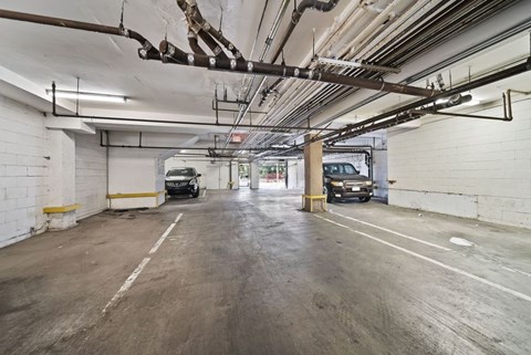 A parking garage with a concrete floor and white walls.