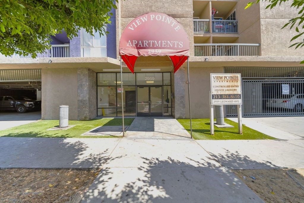 The image shows the front of a building named View Pointe Apartments with a red and white signboard.