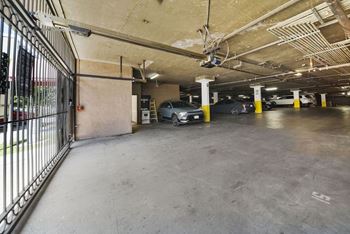 A parking garage with a car parked in the middle.