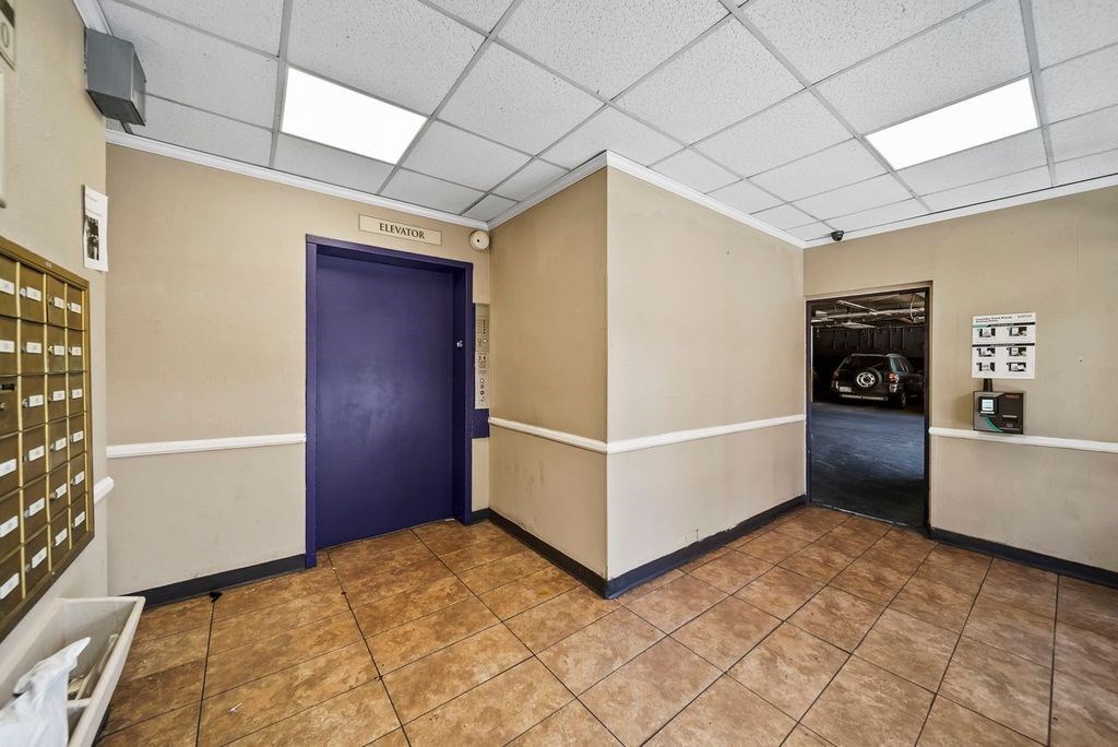 A room with a purple door and a sign that says "LIBRARY".
