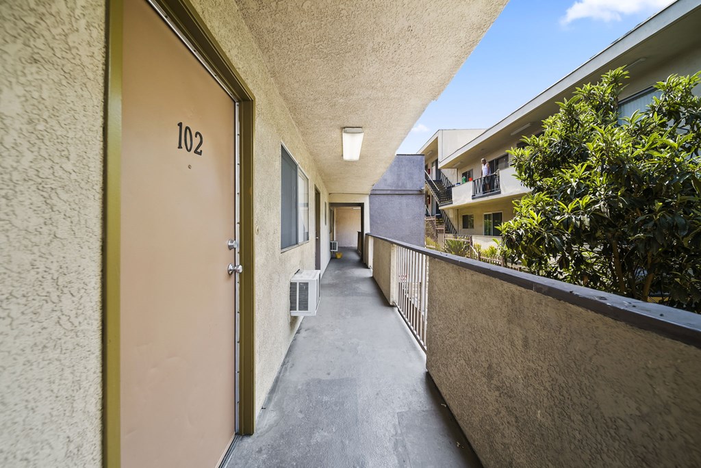 A hallway with a door numbered 102.